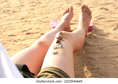 Woman Feets On The Beach.