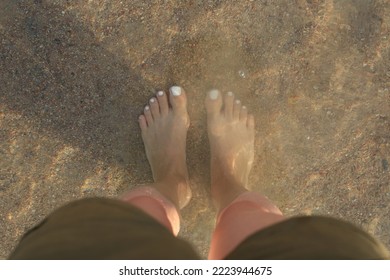 Woman Feets On The Beach.