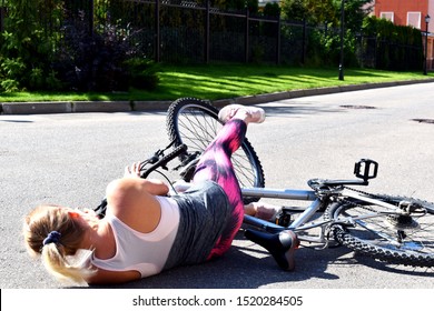 Woman Fell Off Bicycle On Road. The Danger Of Riding Without A Helmet. A Traffic Accident On A Bicycle. Fall From The Bike. 