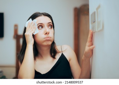 
Woman Felling Hot During Summer Setting Her Thermostat. Person adjusting temperature from the AC settings

