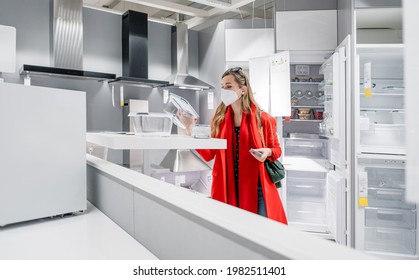 Woman With Ffp2 Mask Shopping White Goods In Kitchen Store