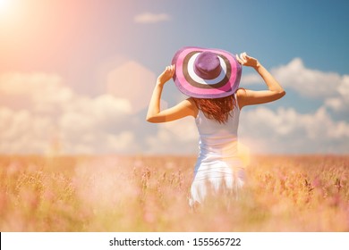 Woman In The Field With Flowers