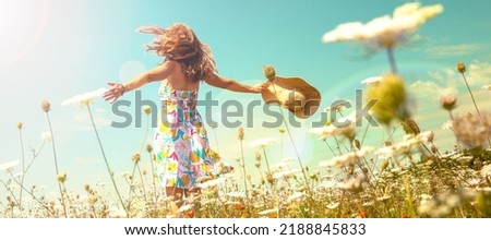 woman in a field with flowers- freedom,  active,  happiness concept