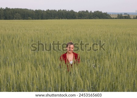 a woman in a field with her beloved pet on a walk. Summer in nature