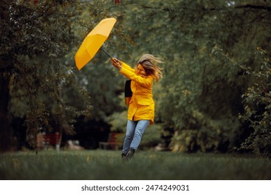 
Woman Fighting Wind Blow During a Rainstorm Tempest. Strong windy bad weather being dangerous and risky
