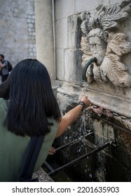 Woman Filling A Bottle Of Water   