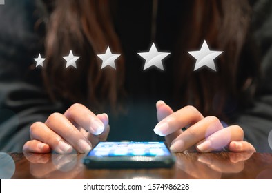 Woman Filling Out 5 Star Silver Customer Service Feedback Survey By Email On Smartphone Device After Hotel Guest Experience - Company Satisfaction Rating, Retention And Quality Of Service Concepts