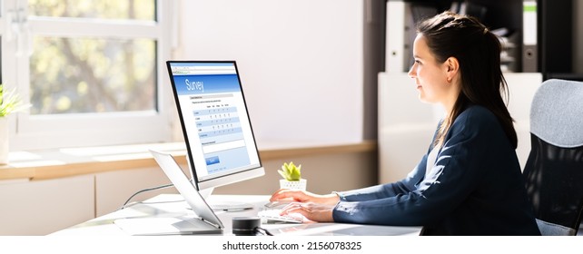 Woman Filling Survey Poll Or Form On Desktop Computer