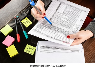 Woman Fills The Tax Form, Working With Tax Documents.Form 1040 Individual Income Tax Return Form. United States Tax Forms 2016/2017. 