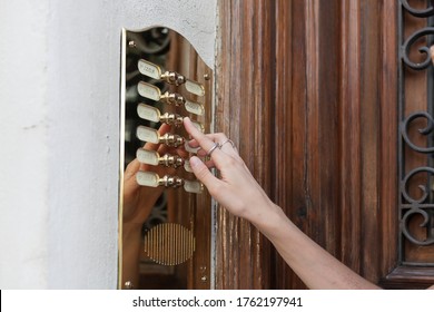 Woman Finger Pushing Door Bell Vintage Button. Ring The Buzzer And Visiting After Coronavirus Pandemic Con New Normal Concept.