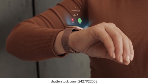 Woman fingers does double tap on smart watch for hands-free interaction. 3d rendering incoming call on smart watch. Young woman is typing on laptop at the work table at the office. - Powered by Shutterstock