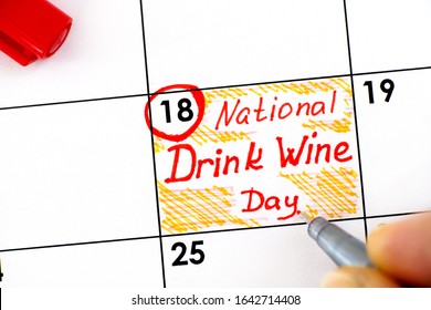 Woman Fingers With Pen Writing Reminder National Drink Wine Day In Calendar. February 18.