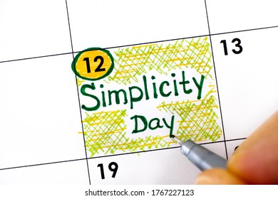 Woman Fingers With Pen Writing Reminder Simplicity Day In Calendar. July 12