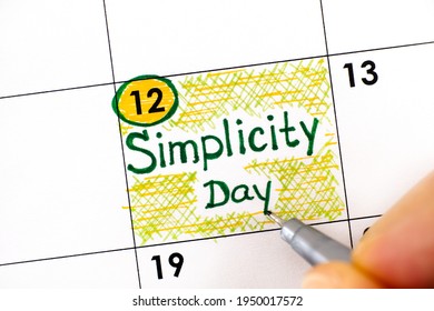 Woman Fingers With Pen Writing Reminder Simplicity Day In Calendar. July 12. 