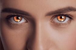 Woman With Fire Burning In Her Eyes, Closeup. Evil Eye