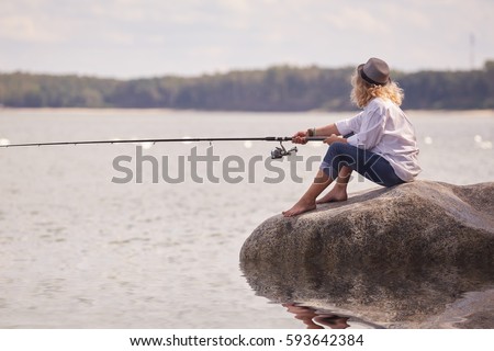 woman fisher sitting on summer sea beach