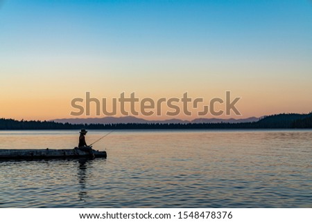 Woman Fishing Lake Tahoe During Sunset