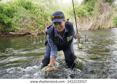 woman fishing in the river