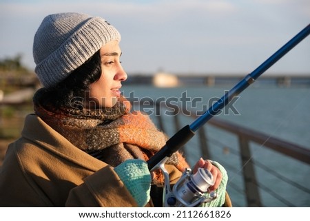woman fishing with fishing rod