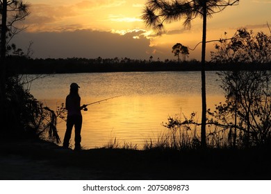 Woman fishing at sunset on lake in Everglades National Park in Florida. - Powered by Shutterstock