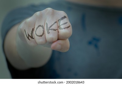 Woman Fist With Woke Written. Woke Concept Refers To Awareness Of Social And Racial Justice, Concern, Vigilance, Activism.