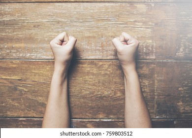 woman fists clenched on a wooden table in anger - Shutterstock ID 759803512