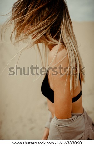 Similar – Image, Stock Photo Young woman at the stand blond hair blows around her