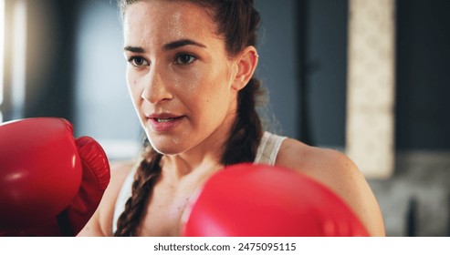 Woman, fitness and boxing in gym for training, self defense and exercise for development. Power workout, gloves and female athlete with equipment for sport, sweating and fighting with hard work - Powered by Shutterstock