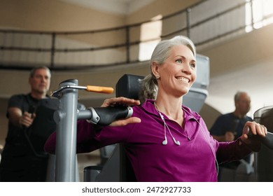 Woman, fitness and chest press machine for training, sports and power performance or action. Female person, mature and equipment at gym for exercise, challenge and strong muscle for bicep pump - Powered by Shutterstock