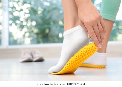 Woman Fitting Orthopedic Insole Indoors, Closeup. Foot Care