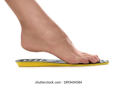 Woman Fitting Orthopedic Insole On White Background, Closeup. Foot Care