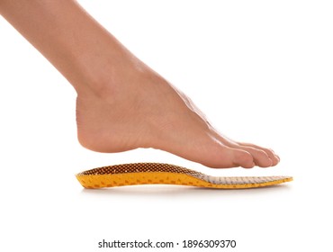 Woman Fitting Orthopedic Insole On White Background, Closeup. Foot Care