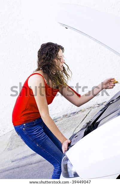 woman fixing\
car