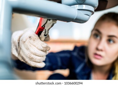 Woman Fixing Kitchen Sink