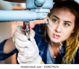 Woman Fixing Kitchen Sink