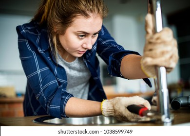 Woman Fixing Kitchen Sink