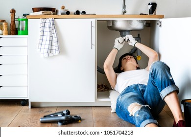 Woman Fixing Kitchen Sink