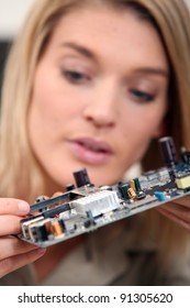 Woman fixing a motherboard