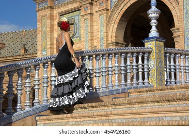 Woman With Flamenco Dress Climbing The Stairs To Spain Square