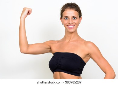 Woman flexing biceps - Shutterstock ID 383985289