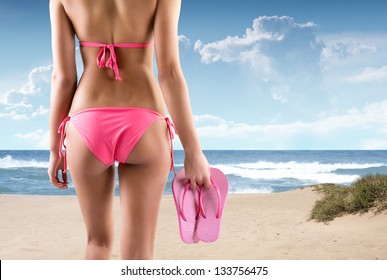 Woman With Flip Flops On A Beach