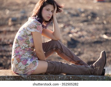 Woman in Floral Dress and Thigh High Boots Outdoors