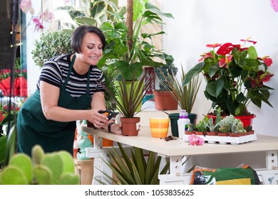 Woman Florist In Apron And Tool In Flower Shop