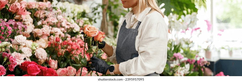 Woman florist flower shop owner hold roses on floral background. High quality photo - Powered by Shutterstock