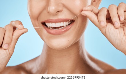 Woman floss teeth zoom, smile and dental healthcare, fresh breath and mouth cleaning isolated on blue background. Face, hands and happy with oral hygiene product, healthy gums and flossing in studio - Powered by Shutterstock