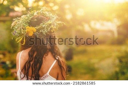 Woman in flower wreath on sunny meadow, Floral crown, symbol of summer solstice. Foto stock © 