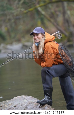woman fly fishing in river