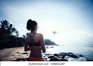 Woman Flying Drone Which Taking Photo Over Sea