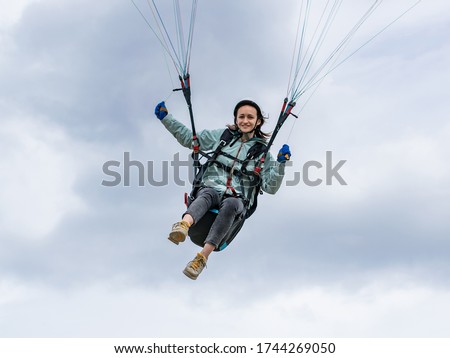 A woman flying a paraglider