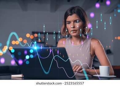 Woman focused on laptop with financial charts overlay, in a modern office setting. Concept of technology, finance, and data analysis business - Powered by Shutterstock